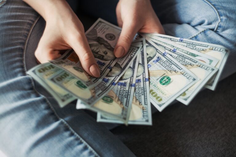 Illustartion shows a human hand showing USDs