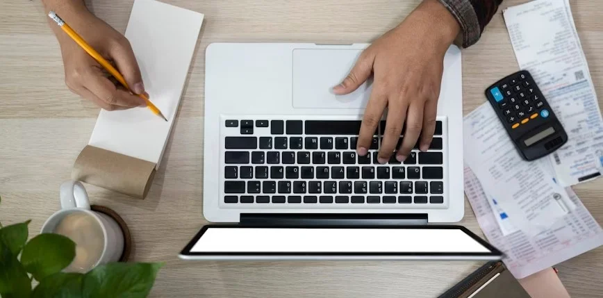 Illustartion shows a human kearning on laptop and writing on a note book