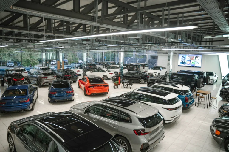 Luxury cars lined up inside a bright showroom